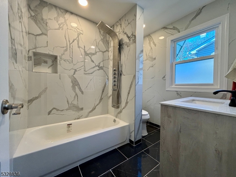 89 Hay Avenue Nutley, NJ 07110 - Photo 17 of 24 a bathroom with a bathtub and a shower