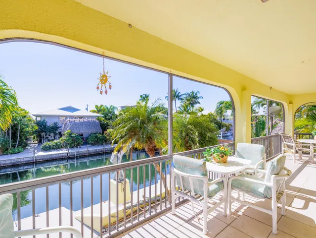 a very nice looking open kitchen with stainless steel appliances kitchen island granite countertop a refrigerator and a stove