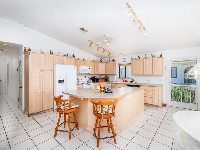 a kitchen with stainless steel appliances kitchen island granite countertop a sink and cabinets