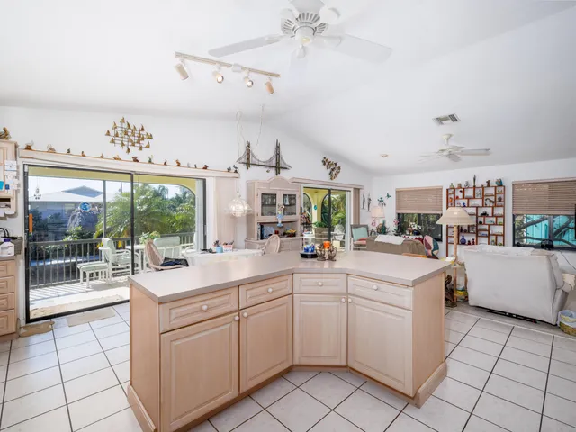 a living room with furniture and a kitchen view