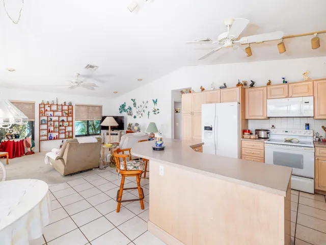 a living room with furniture a lamp and a window