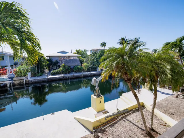 a view of a patio with table and chairs under an umbrella