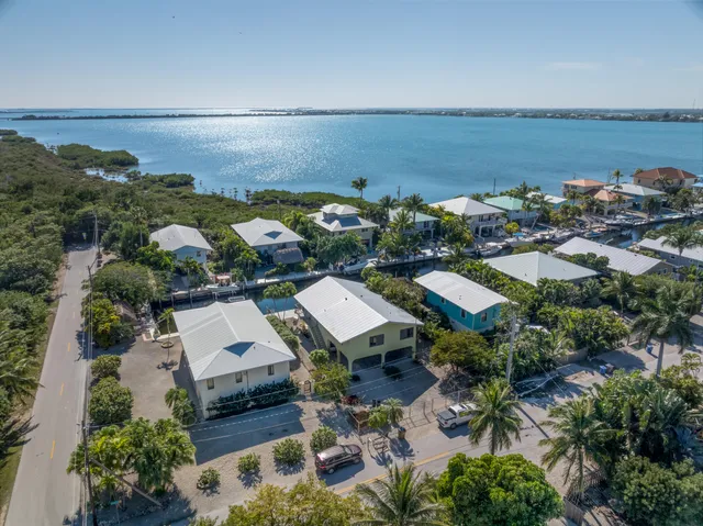 an aerial view of a house with a ocean view