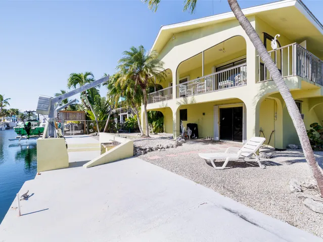 a view of staircase with furniture and a potted plant