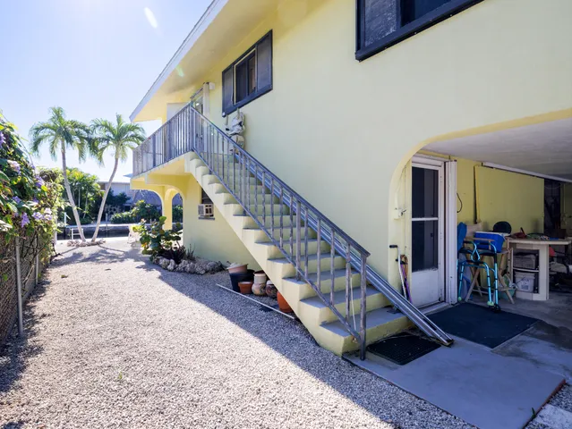 a view of a patio with couches table and chairs and potted plants