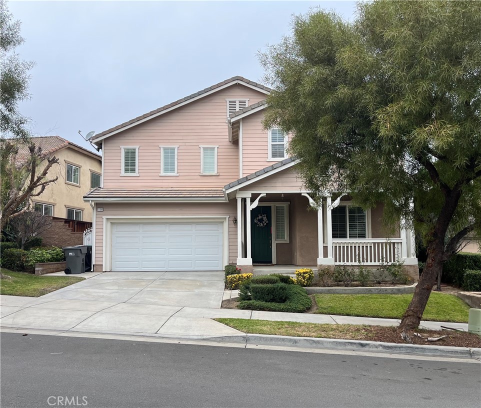 11190 Tesota Loop Street Corona, CA 92883 - Photo 1 of 1 a front view of a house with a garden and trees