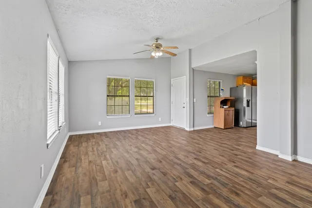 a kitchen with stainless steel appliances granite countertop a refrigerator a stove top oven a sink and dishwasher