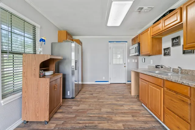 a kitchen with stainless steel appliances granite countertop a sink and cabinets