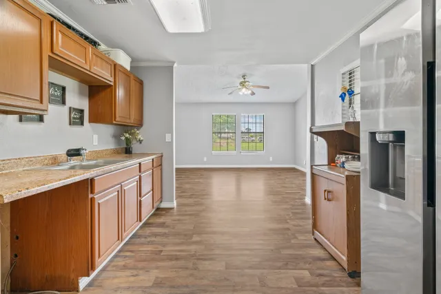 an empty room with a window and a fan