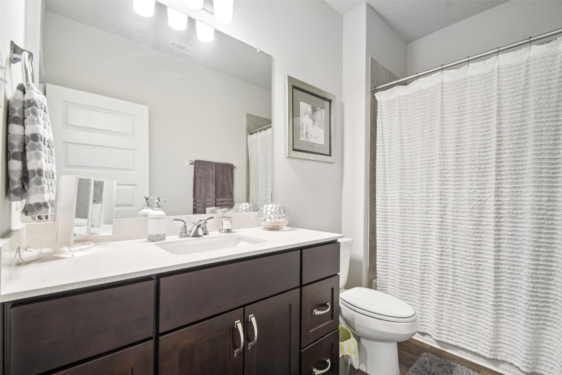 5525 Sacra Cove Austin, TX 78747 - Photo 15 of 20 a bathroom with a sink toilet and mirror