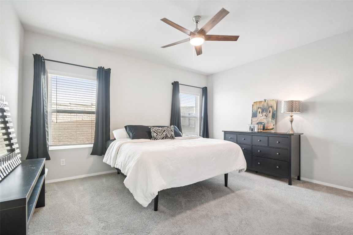 5525 Sacra Cove Austin, TX 78747 - Photo 7 of 20 a bedroom with a large bed and a window