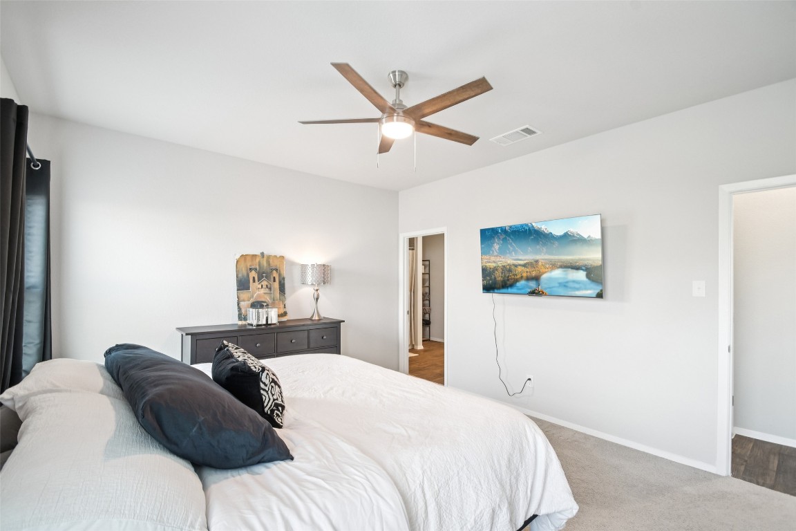 5525 Sacra Cove Austin, TX 78747 - Photo 8 of 20 a bedroom with a bed and a painting on the wall