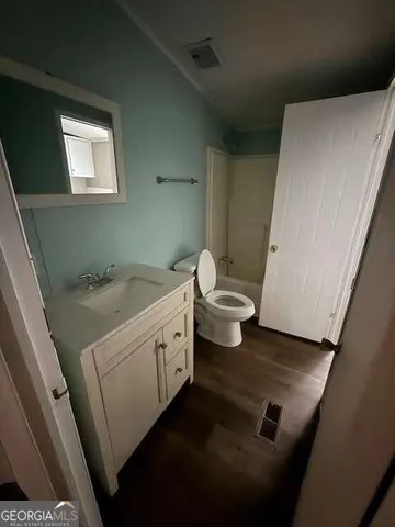 a bathroom with a sink a toilet and vanity