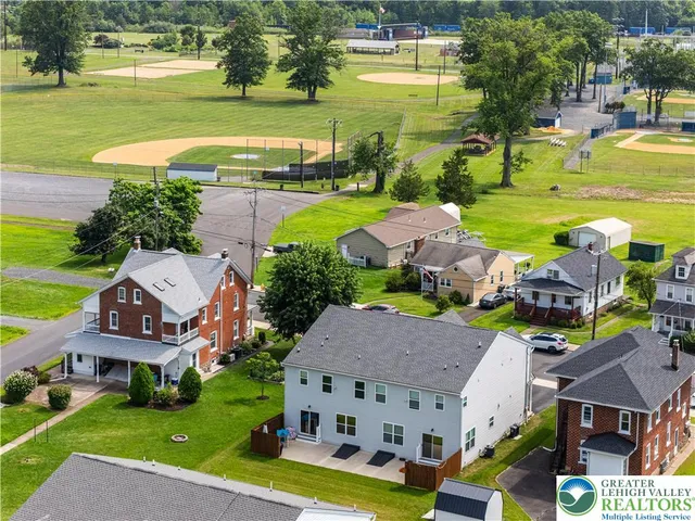 an aerial view of a house with a garden potted plants and large trees