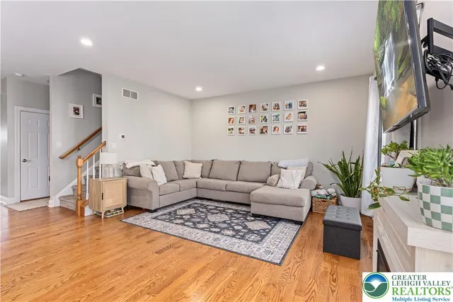 a living room with furniture rug and wooden floor