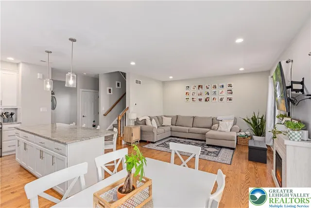 a living room with furniture and a chandelier