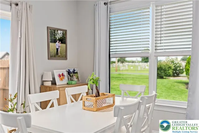 a living room with patio furniture and a potted plant