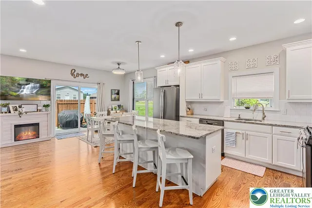 a large kitchen with a table and chairs