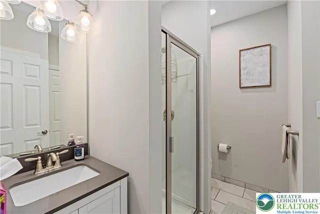 a bathroom with a sink a light fixture and a mirror