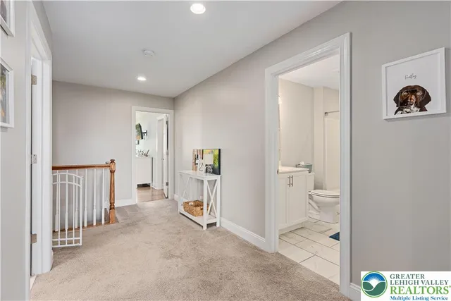 a view of a hallway with closet and a bathroom