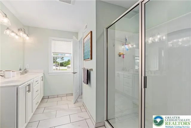 a bathroom with a shower sink and mirror