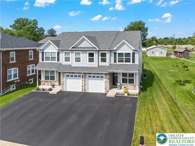 a front view of a house with a yard table and chairs