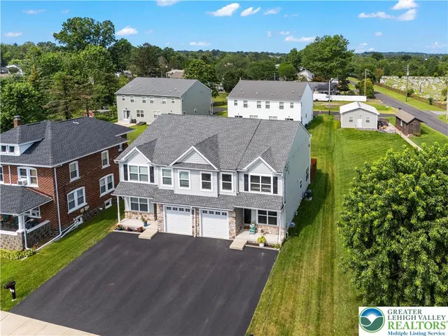 an aerial view of a house with a big yard