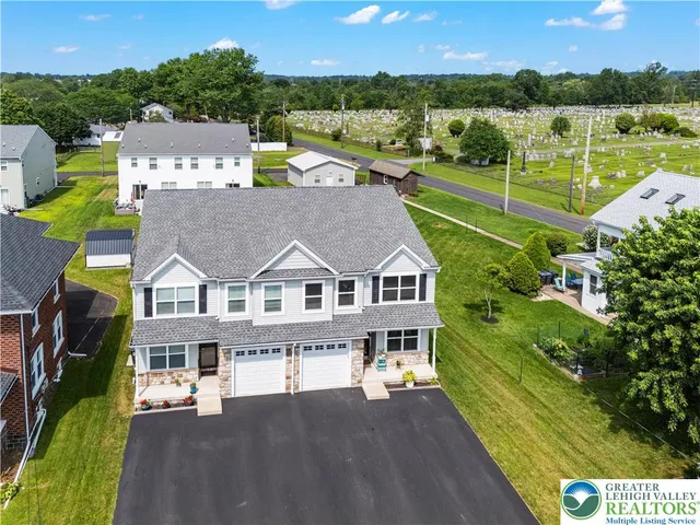 an aerial view of a house with a big yard