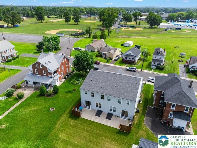 an aerial view of a house with outdoor space swimming pool and green space