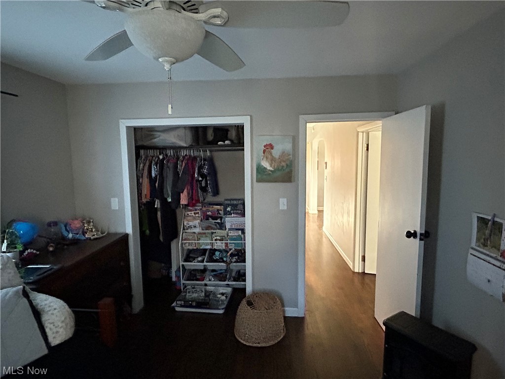 1312 Aberagg Road Atwater, OH 44201 - Photo 13 of 23 Bedroom featuring a closet, ceiling fan, and dark hardwood / wood-style flooring