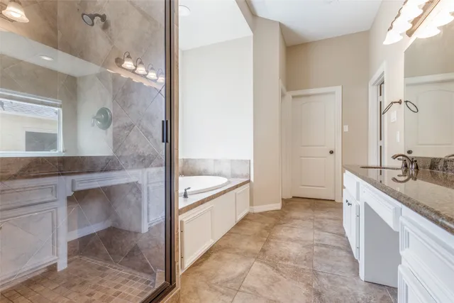 a bathroom with a tub sink and mirror