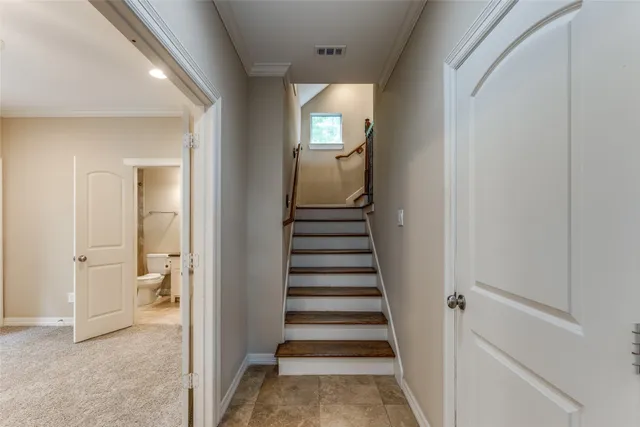 a view of a hallway with wooden floor and entryway
