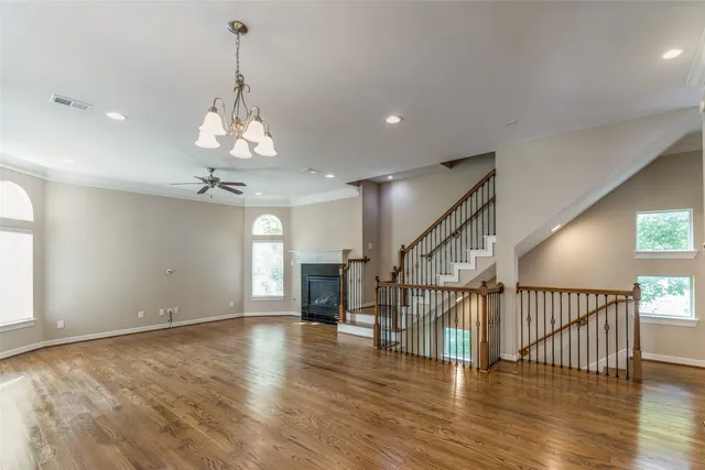 a view of an empty room and wooden floor
