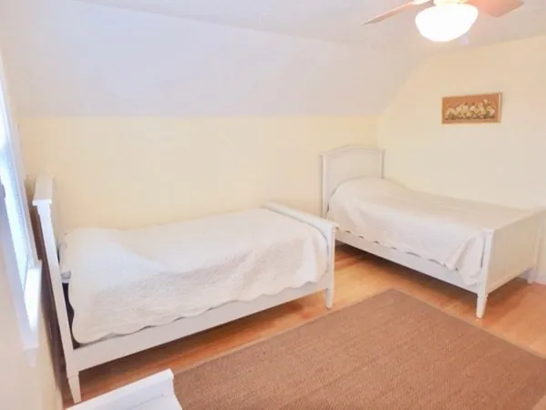 a bedroom with a bed and a wall painting