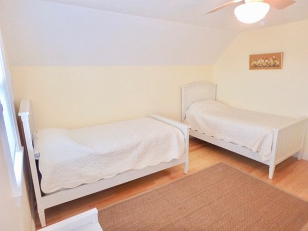 5 Laurel Avenue Oak Bluffs, MA 02557 - Photo 14 of 25 a bedroom with a bed and a wall painting