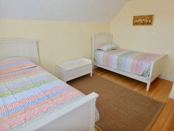 5 Laurel Avenue Oak Bluffs, MA 02557 - Photo 16 of 25 a bedroom with a bed and a night stand