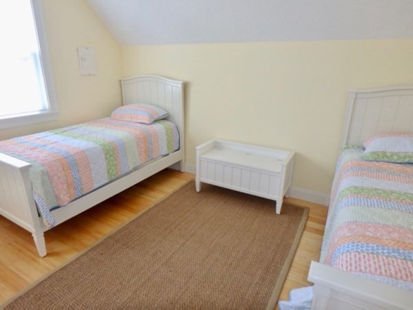 5 Laurel Avenue Oak Bluffs, MA 02557 - Photo 17 of 25 a bedroom with a bed and a night stand