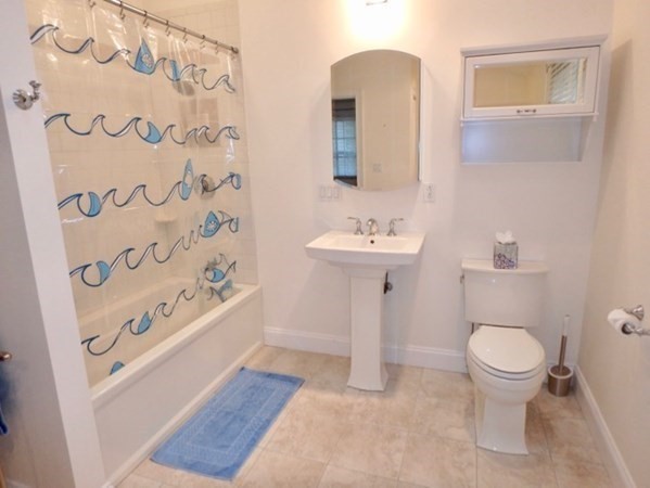 5 Laurel Avenue Oak Bluffs, MA 02557 - Photo 19 of 25 a bathroom with a toilet sink and mirror