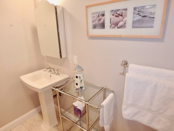 5 Laurel Avenue Oak Bluffs, MA 02557 - Photo 21 of 25 a bathroom with a sink and a refrigerator