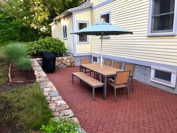 a view of a patio with a table and chairs and potted plants