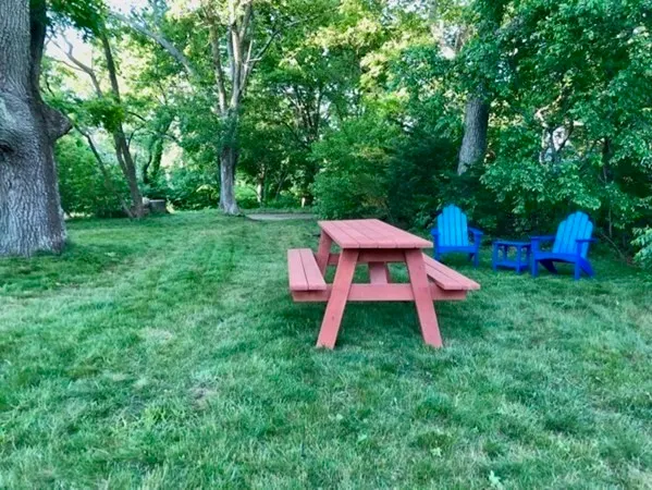 a backyard of a house with table and chairs