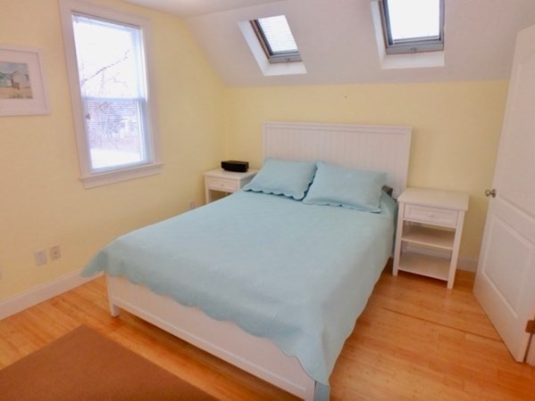 5 Laurel Avenue Oak Bluffs, MA 02557 - Photo 9 of 25 a bed sitting in a bedroom next to a window