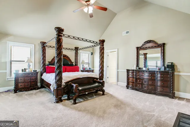 a bedroom with furniture and a chandelier