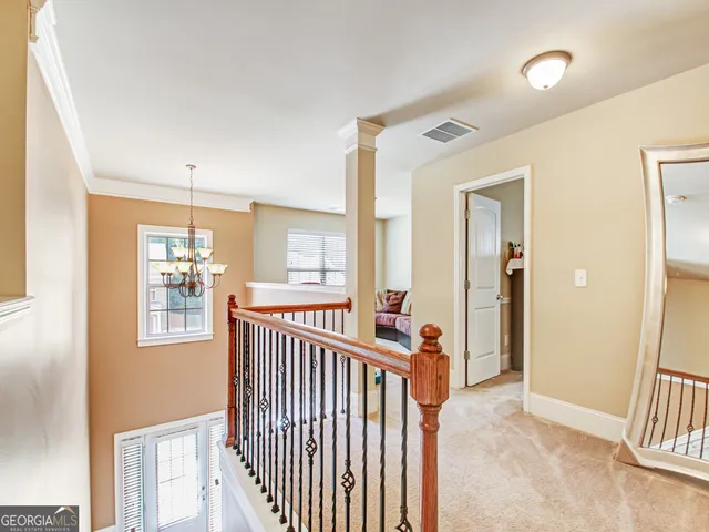 a view of a hallway with windows and stairs