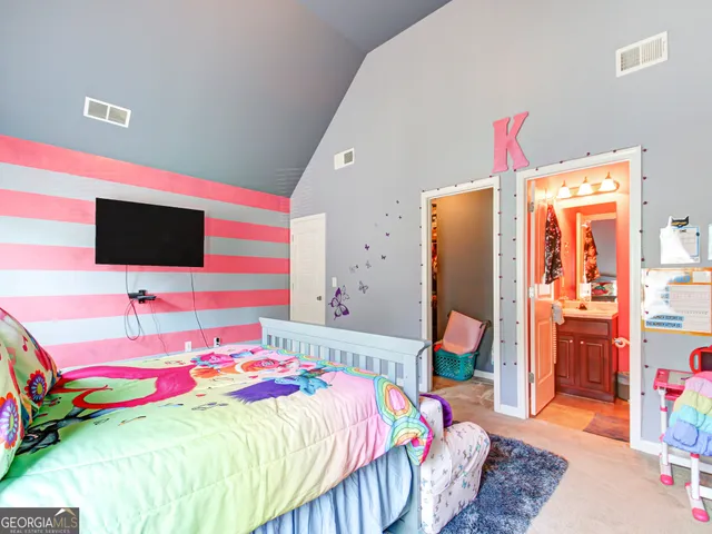 a bedroom with a bed and flat screen tv