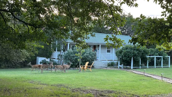 a house view with a sitting space and garden