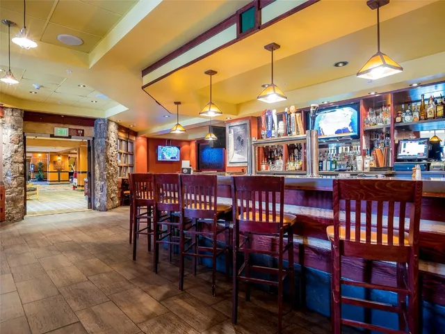 a dining area with a table and chairs