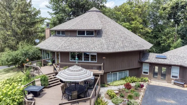 a view of a deck with furniture and a yard