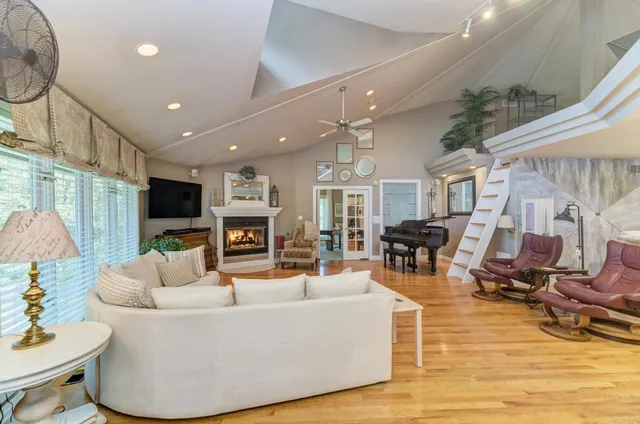 a living room with furniture a fireplace and a flat screen tv