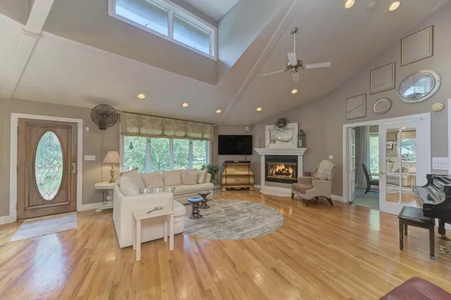 a living room with furniture and wooden floor